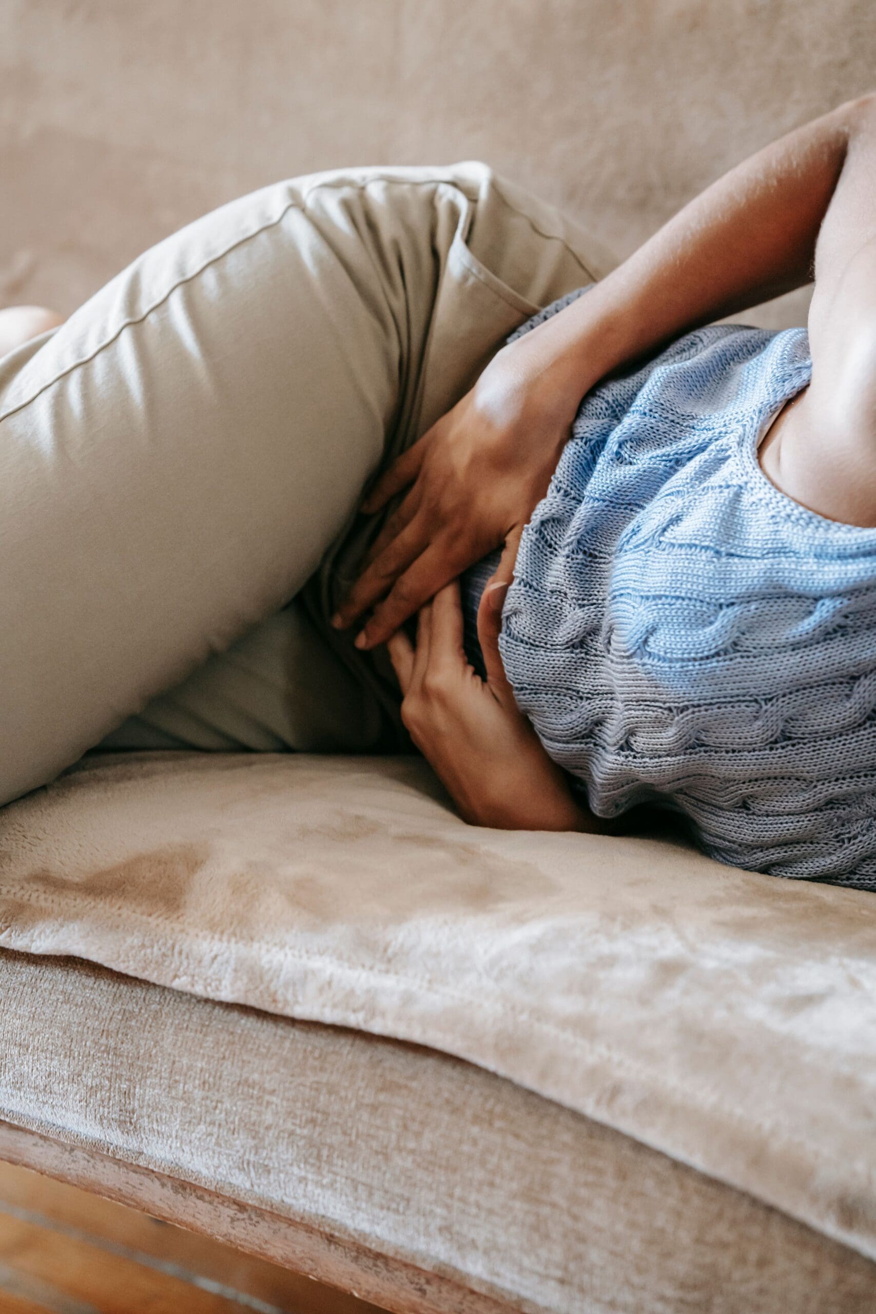 Woman resting with her hands over her lower abdomen